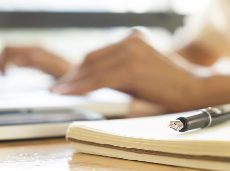 Close up pen and blur bokeh working hands of asian businesswoman Close up pen and blur bokeh working hands of asian businesswoman